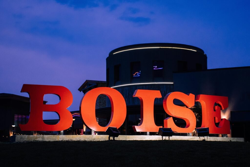 Large red Boise sign illuminated at night, representing the city of Boise, Idaho.